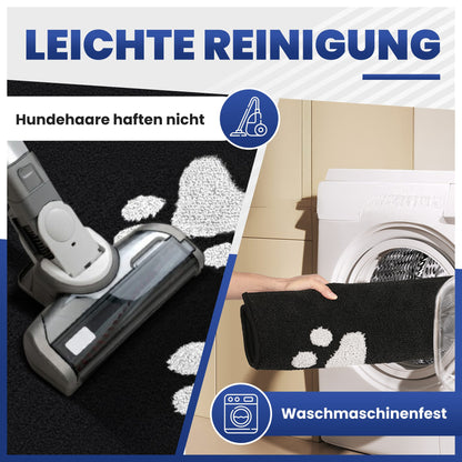 Schwarze Fußmatte mit weißen Pfoten: Staubsauger entfernt Haare, Matte kommt in die Waschmaschine, Leichte Reinigung