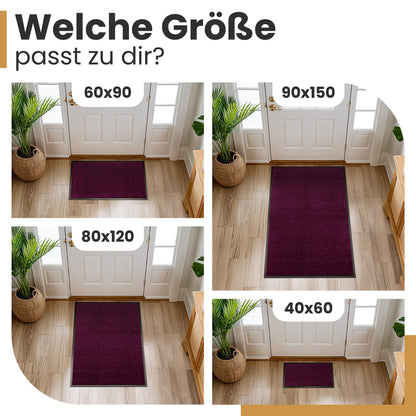 Lila Fußmatte vor einer Haustür in vier Größen: 60x90, 90x150, 80x120 und 40x60 cm, dazu die Frage nach der passenden Größe