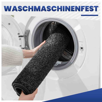 Waschmaschinenfeste, schwarze Fußmatte wird zur einfachen Reinigung in die Waschmaschine gelegt.